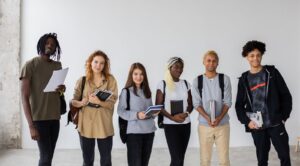 Group of international students holding books and folders