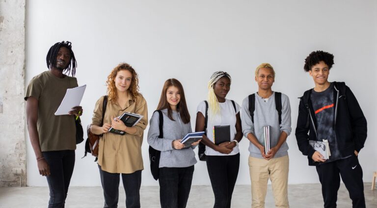Group of international students holding books and folders